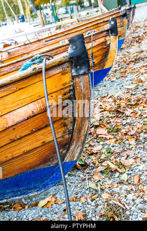 Traditional wooden rowing boats on the lake shore at Bowness-on-Windermere. Stock Photo