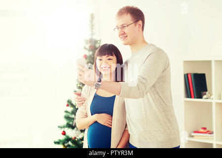 happy family couple taking selfie at christmas Stock Photo