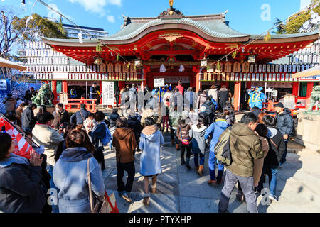 Japanese new year, shogatsu. Shinto Ikuta shrine in Kobe packed with crowds of people conducting their hatsumode, first visit of the new year. Stock Photo