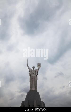 Soviet Motherhood statue with shield and sword, against a cloudy sky, in Kiev Ukraine. Stock Photo