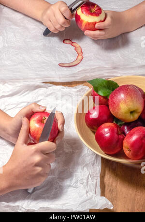 peeling freshly picked apples from the garden mother and daughter white space for text copy Stock Photo