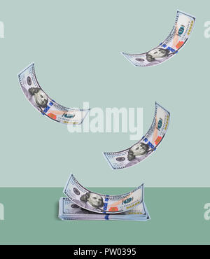Money falling into an orderly stack Stock Photo - Alamy
