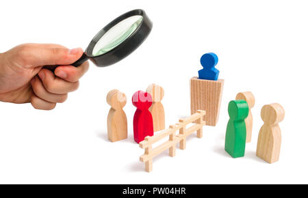 Magnifying glass is looking at the wooden fence divides the two groups discussing the case. Termination and breakdown of relations, breaking ties. Con Stock Photo