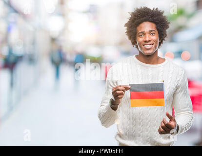 Afro american man flag of Germany over isolated background with a happy face standing and smiling with a confident smile showing teeth Stock Photo