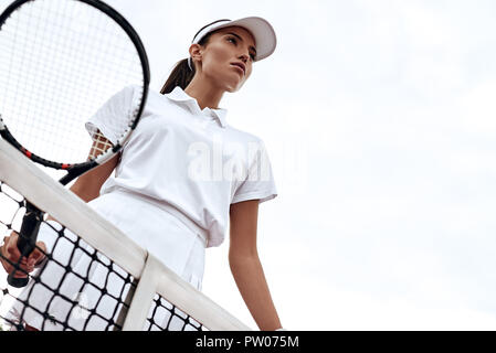 Tennis player playing on the court on a sunny day Stock Photo