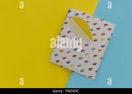 Birthday present gift box on yellow blue background Stock Photo