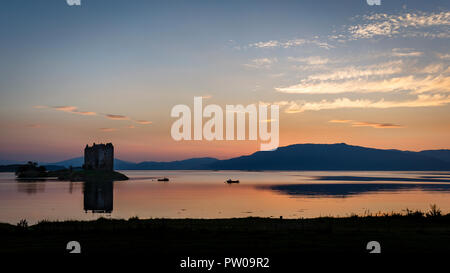 The picturesque Castle Stalker on tidal island in Loch Laich at sunset, Scotland Stock Photo