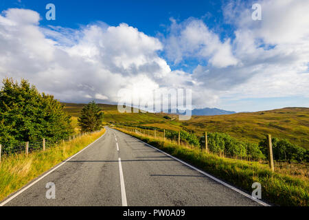 Empty road on Isle of Skye leading towards Black Cuillin Mountains in the distance, Scotland Stock Photo