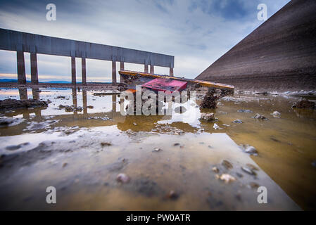 A rusty lock on the bottom of a dry dam. Stock Photo