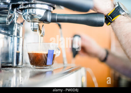 Preparing delicious coffee from coffee machine in the restaurant Stock Photo