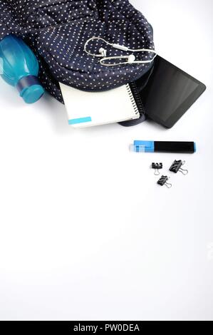 Study stuff. Education background. Stationery. Aspects of education. Stickers, marker, clips, headphones, bagpack, tablet, bottle and notebook inside Stock Photo