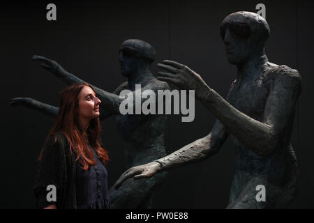 A visitor looks at the work of Elisabeth Frink on display at the Elisabeth Frink Humans and Other Animals exhibition preview at the Sainsbury Centre for Visual Arts in Norwich, Norfolk. PRESS ASSOCIATION Photo. Picture date: Thursday October 11, 2018. The exhibition will provide new perspectives and examine her radical and bohemian beginnings in 1950s London, reappraising one of the most important British sculptors of the twentieth century. Photo credit should read: Chris Radburn/PA Wire Stock Photo