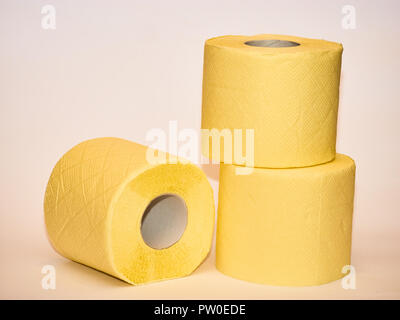 pyramid of yellow toilet paper isolated over white background. Stock Photo