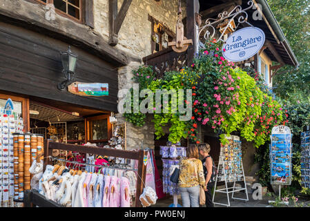 Tourists visiting souvenir shop in the medieval village Yvoire, Haute-Savoie, Auvergne-Rhône-Alpes, France Stock Photo