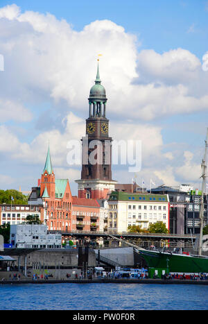 view on the famous Michel of Hamburg in Germany with the Landungsbrücken in the foreground Stock Photo
