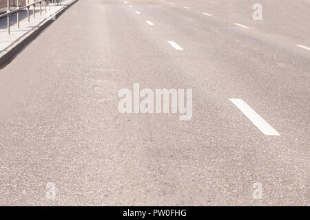 Straight road with white markings close up Stock Photo