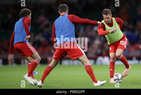 Wales' Aaron Ramsey (right) warms up during the International Friendly match at the Principality Stadium, Cardiff. Stock Photo