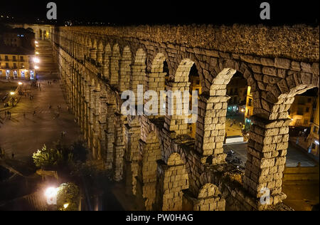 Dramatic arches of ancient Roman Aqueduct towers over plaza in Segovia, a must-see marvel of engineering in Spain, a short train ride from Madrid. Stock Photo