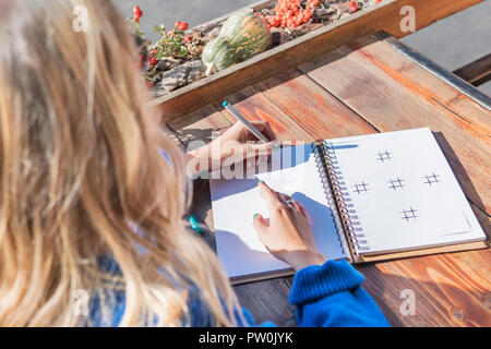 Woman writing in notebook Stock Photo