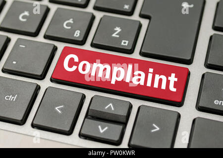 Computer keyboard with grey keys with the word Complaint on red conceptual of online dissatisfaction, returns or poor quality. Stock Photo