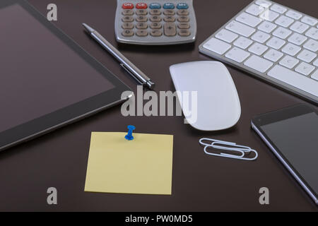 Office desk with digital tablet smartphone keyboard and mouse. Business workspace concept with blank paper for your text. Stock Photo