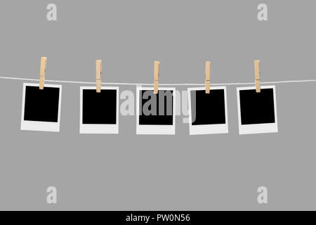 Old picture frame hanging on clothesline on background. Stock Photo