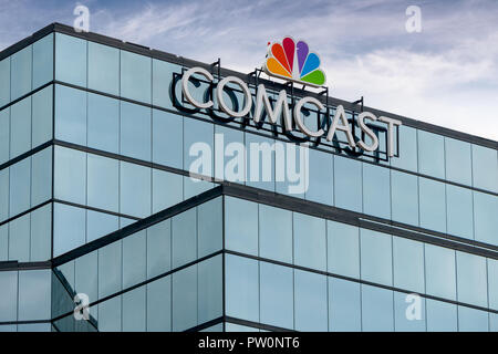 ST. PAUL, MN/USA - SEPTEMBER 30, 2018: Comcast Corporation regional headquarters and trademark logo. Stock Photo