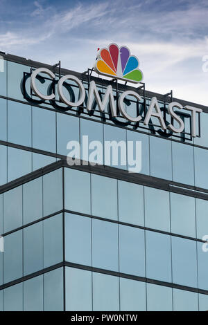 ST. PAUL, MN/USA - SEPTEMBER 30, 2018: Comcast Corporation regional headquarters and trademark logo. Stock Photo