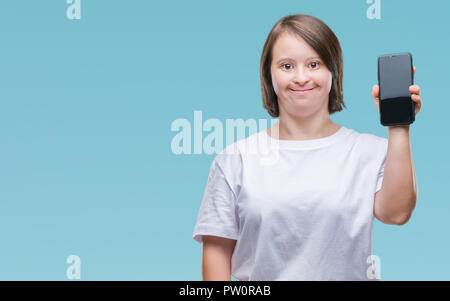 Young adult woman with down syndrome showing smartphone screen over isolated background with a happy face standing and smiling with a confident smile  Stock Photo