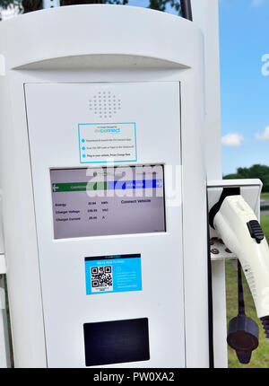 Public electric vehicle charging station with one car being charged shown of display, Rochester, New York, USA Stock Photo