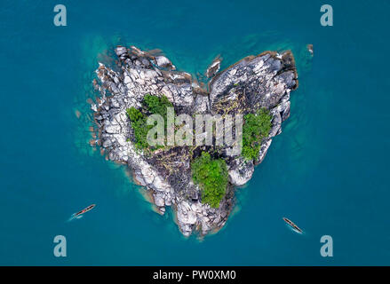 Heart shaped island, heart island in lake with canoe boats peddling to the shores. Aerial photo of heart isle in the ocean and lake Malawi kande beach Stock Photo