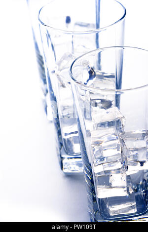 three glasses of water with ice cubes, close up, isolated on white ...