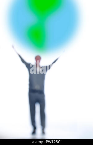 Concept A Business Man with Briefcase, Standing with Arms Up, Catching a Globe, Earth, The World is Yours, New Beginning, Embracing Stock Photo
