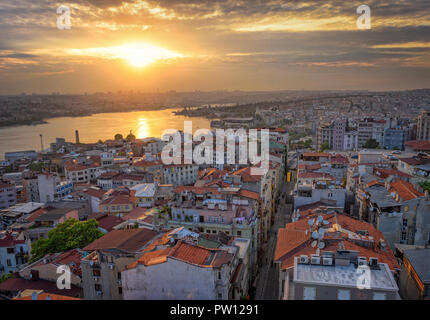 Sunset in Istanbul Turkey seen from Galata Tower over the river bosphorus and golden horn, soft sun light cityscape skyscrapers and skyline istanbul