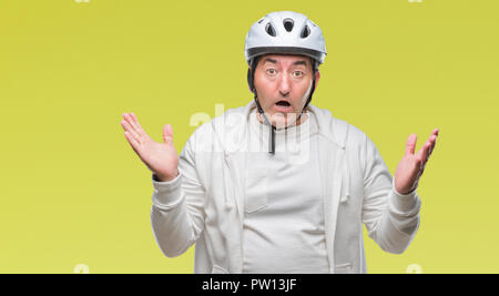 Handsome senior cyclist man wearing bike helmet over isolated background very happy and excited, winner expression celebrating victory screaming with  Stock Photo