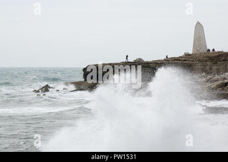 Portland Bill, Dorset, UK. 11th October, 2018. The first major storm of the autumn arrives in south Dorset on the world famous Jurassic coastline at Portland Bill. The exposed peninsular of land feels the early stages of storm Callum as onlookers brave the extreme conditions, strong gales, high waves and sea spray. The first stages of the storm starts to move across the country on Thursday through to the weekend, bringing winds in excess of 60mph rain and potential damage to property in exposed areas. Credit: Wayne Farrell/Alamy Live News Stock Photo