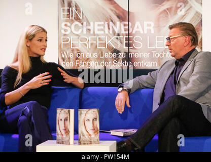 Frankfurt, Germany. 11th October 2018. Swiss television hostess Michelle Hunziker (left) and German journalist Matthias Hugle (right) talk at a talk at the Frankfurt Book Fair. The 70th Frankfurt Book Fair 2018 is the world largest book fair with over 7,000 exhibitors and over 250,000 expected visitors. It is open from the 10th to the 14th October with the last two days being open to the general public. Stock Photo