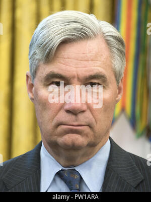 Washington, District of Columbia, USA. 11th Oct, 2018. United States Senator Sheldon Whitehouse (Democrat of Rhode Island) looks on as US President Donald J. Trump makes remarks prior to signing S. 3508, the 'Save Our Seas Act of 2018'' in the Oval Office of the White House in Washington, DC on Thursday, October 11, 2018. Credit: Ron Sachs/CNP Stock Photo