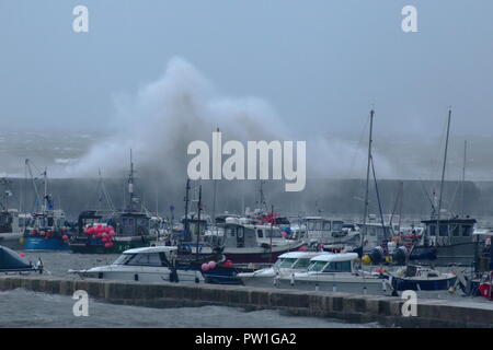 Lyme Regis, Dorset, UK, 12th October, 2018: UK Weather. Huge waves generated by Storm Callum hit the Cobb harbour at Lyme Regis in Dorset. Credit: Savo Ilic/Alamy Live News Stock Photo