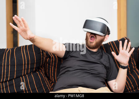 Bearded man wearing virtual reality goggles Stock Photo