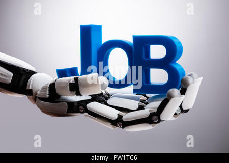 Robot Holding Blue Job Word On Gray Background Stock Photo