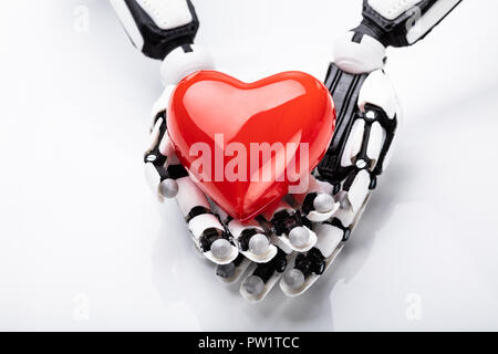 Elevated View Of Robotic Hand Holding Red Heart Stock Photo