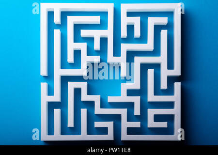 High Angle View Of White Maze On Blue Background Stock Photo