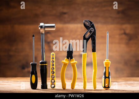 Row Of Various Worktools On Wooden Desk Stock Photo