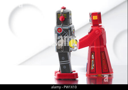 Concept Vintage Metal Toy Robot Holding Hands, Falling in Love, Robot Tenderness, Vintage Robots Stock Photo