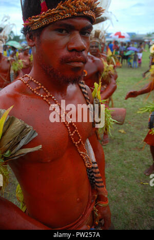 Colourfully dressed and face painted man as part of a Sing Sing in Madang, Papua New Guinea. Stock Photo
