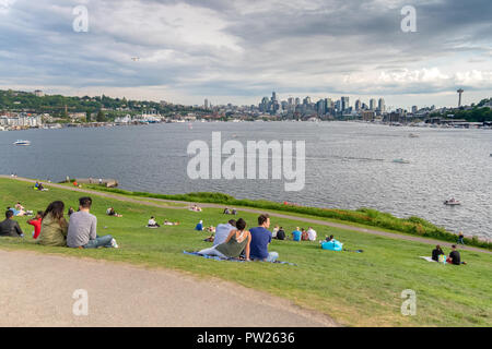 SEATTLE, WA, MAY 6, 2018: Dozens of people visit Gas Works Park to view Seattle's skyline across Lake Union. Stock Photo