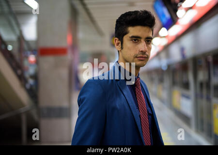 Young handsome Persian businessman exploring the city of Bangkok Stock Photo