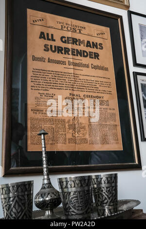 Jerusalem, Israel. 11th October, 2018. An original print of The Palestine Post from May 7th, 1945, announcing Germany's surrender ending WWII, is framed and exhibited inside the Indian Hospice library. The Indian Hospice, serving as a lodge for devote Indian Muslims passing through Jerusalem on their way to and from Haj in Mecca, is located just inside the Herod's Gate in Jerusalem's Old City. Established some 800 years ago following the a visit by Hazrat Farid ud-Din Ganj Shakar, or Baba Farid, from the Chisti order of Sufis, has been managed by the Indian Muslim Ansari family for close to 10 Stock Photo