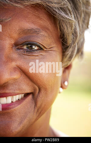 Close Up Of Smiling Senior Womans Eyes In Park Stock Photo